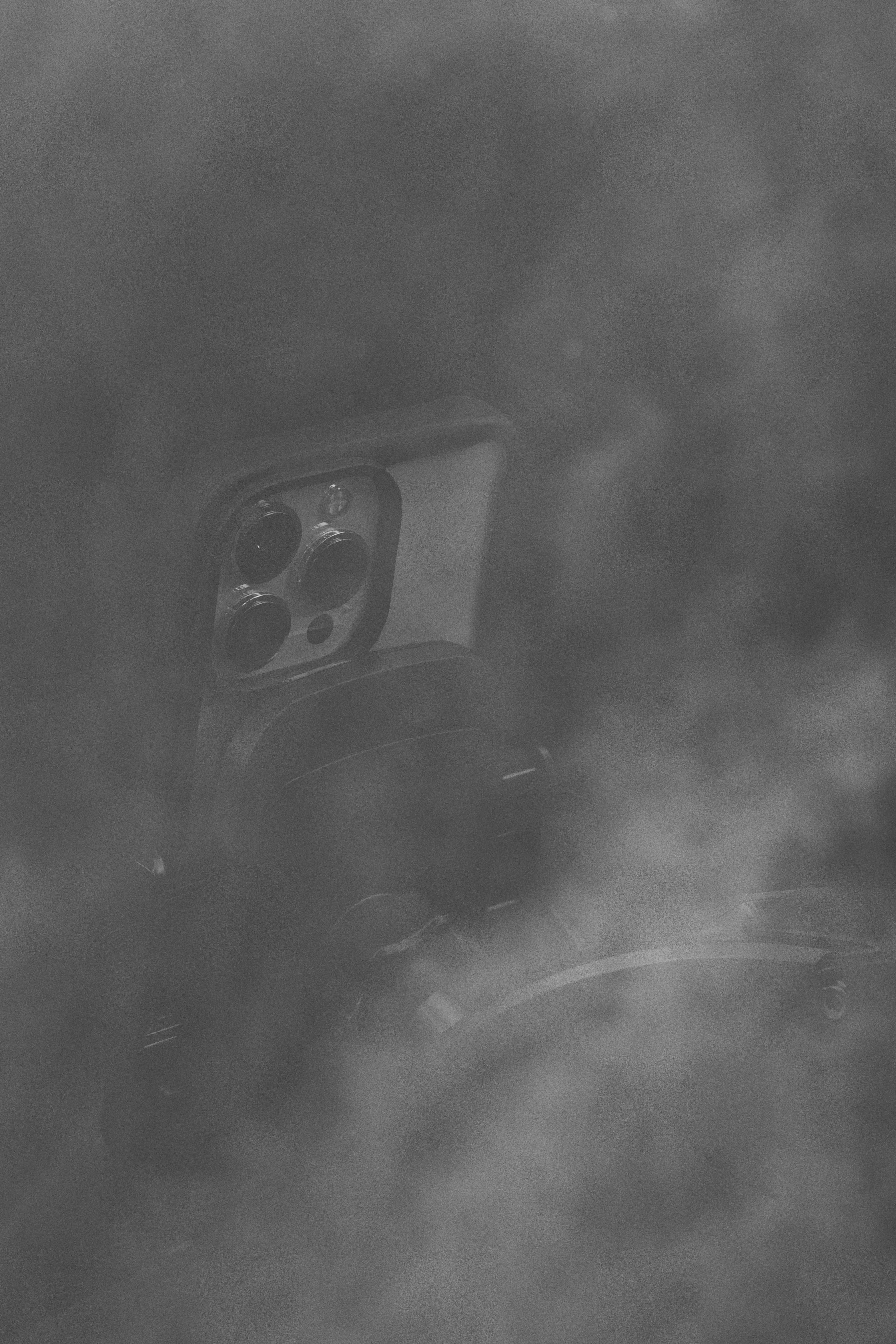 a black and white photo of a mirror in the fog