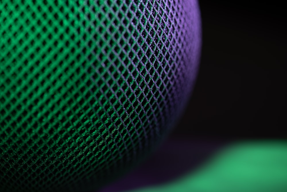 a close up of a green and purple speaker