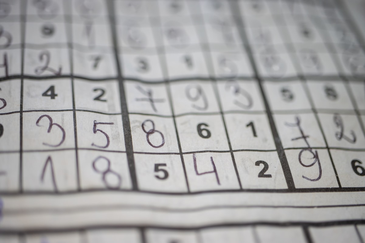 Close-up of a sudoku grid on paper, analog-attention register