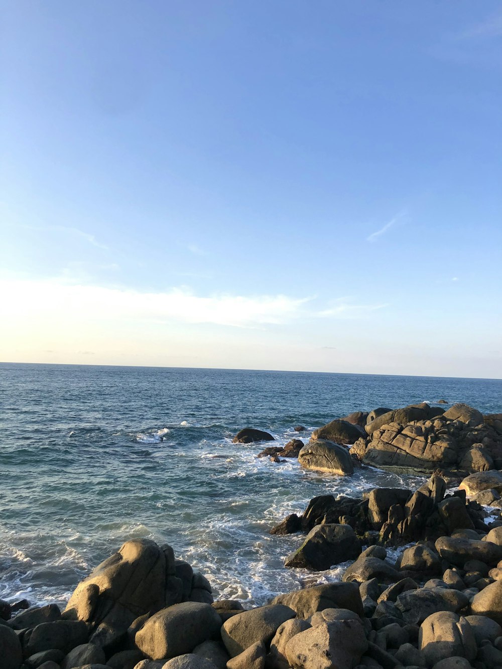 a rocky shore line with a body of water