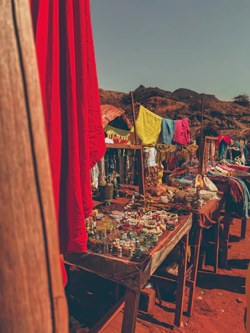 A colorful Mexican market bustling with locals and vibrant crafts under bright blue skies.