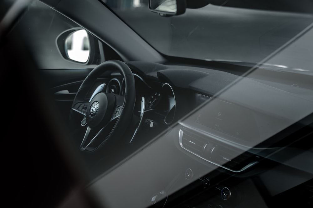 the interior of a car with a steering wheel and dashboard