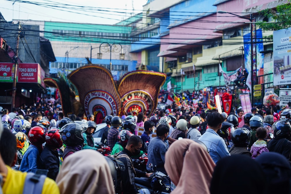 a large group of people riding motorcycles down a street