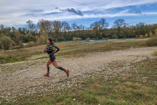 A runner sprinting on a scenic trail.