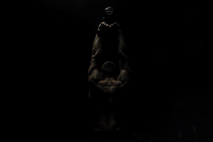 Athlete training in a moody, dimly lit gym after hours