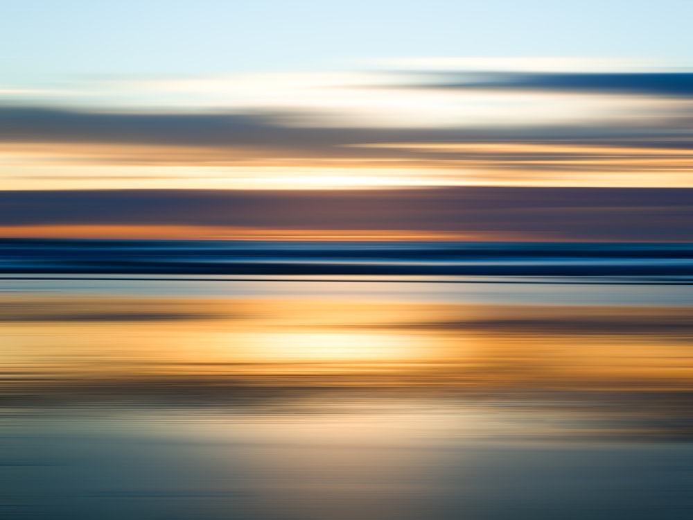 a blurry photo of a sunset over the ocean