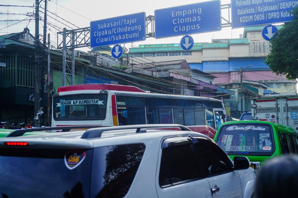 a street filled with lots of traffic next to tall buildings