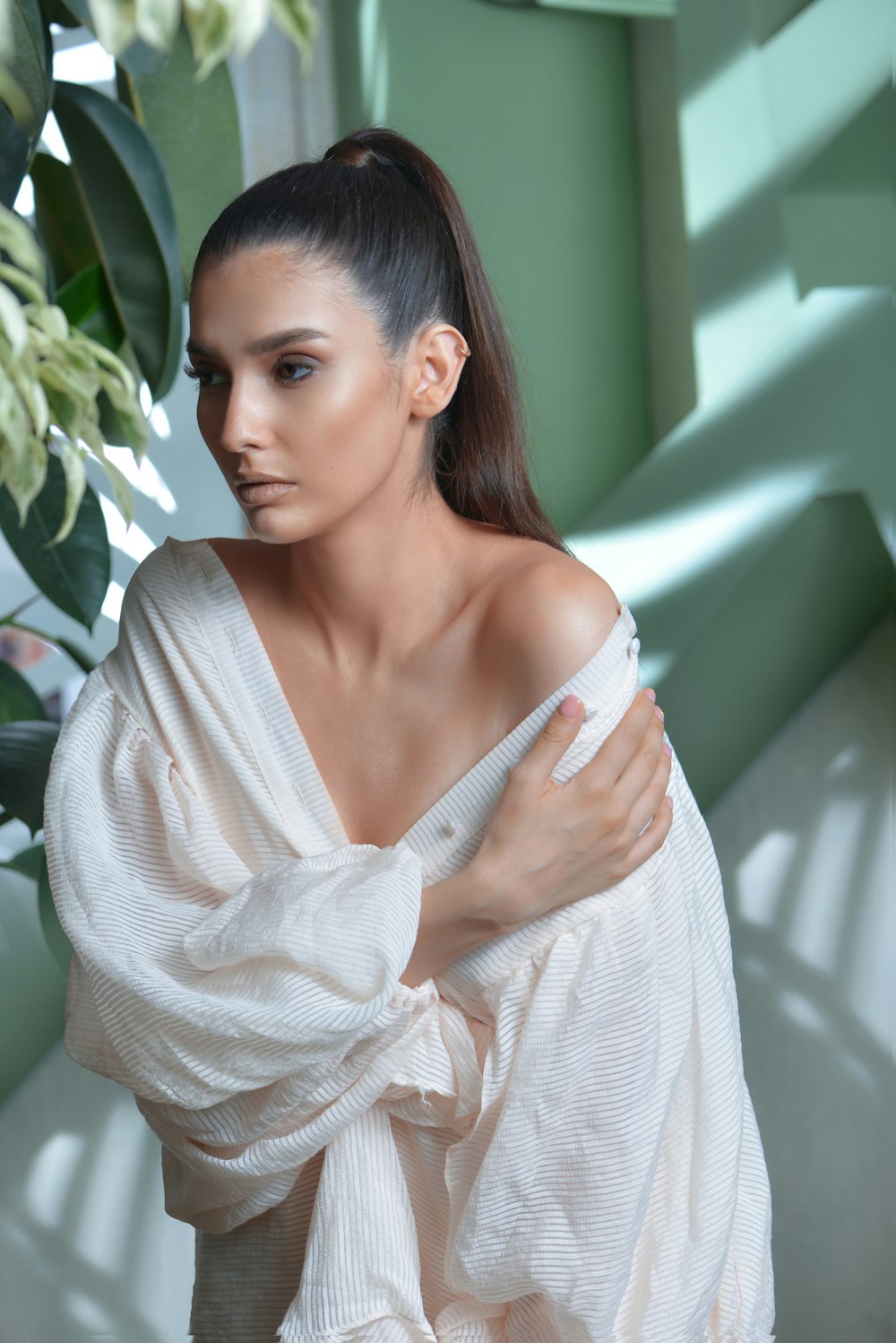 a woman in a white dress is posing for a picture