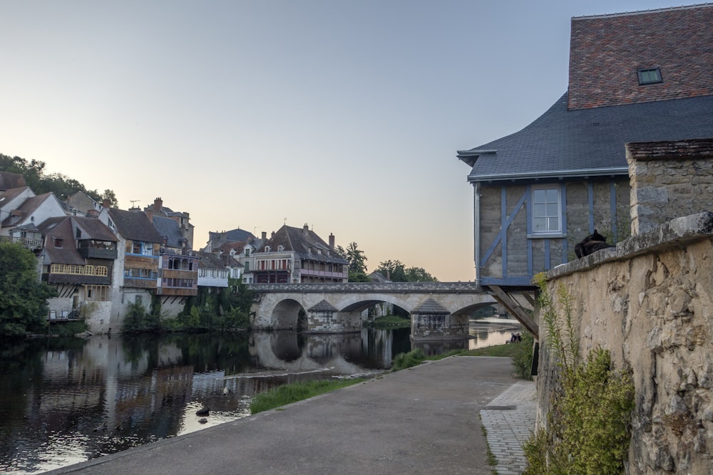 a bridge over a river next to a small town