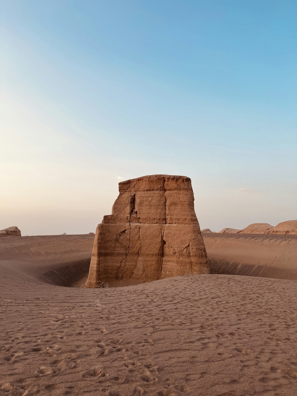 a rock formation in the middle of a desert