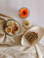 Small decorative display stands arranged with soft cream backgrounds to emphasize texture.
