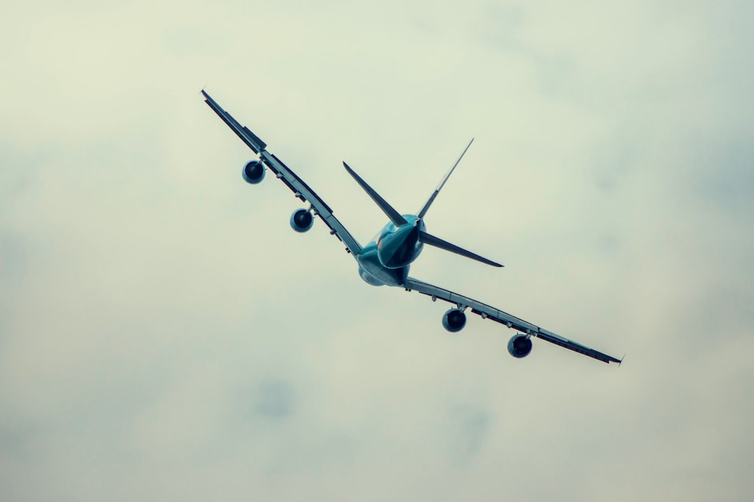 an airplane is flying in the sky on a cloudy day,