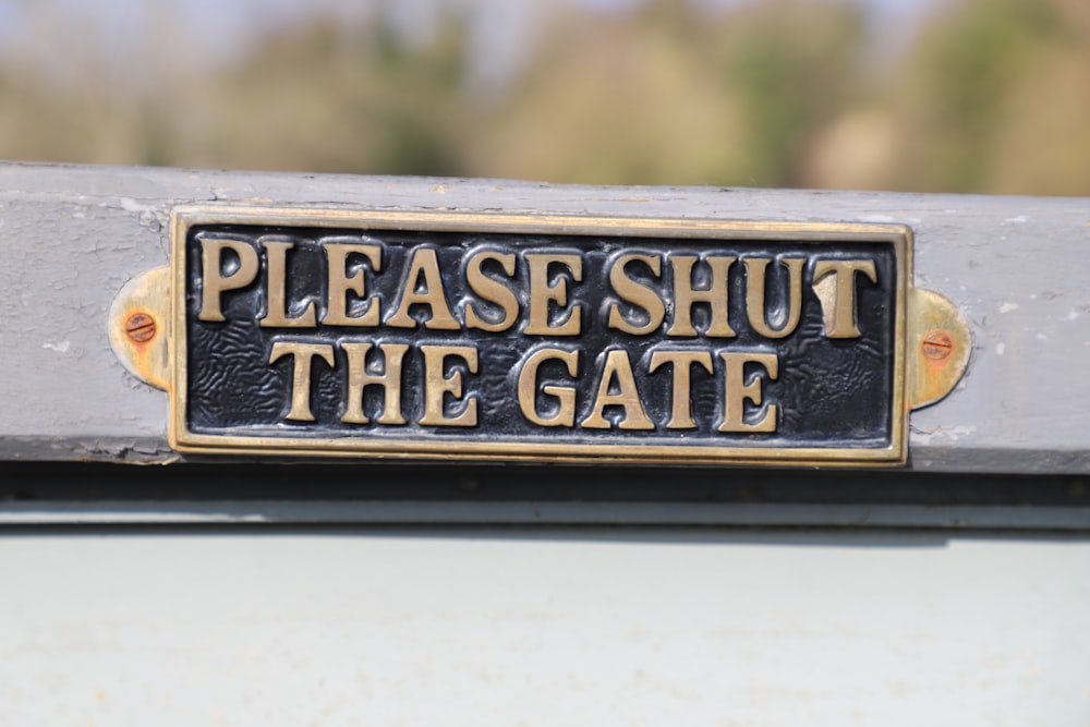 a sign that says please shut the gate