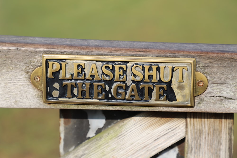uma placa que diz, por favor, feche o portão
