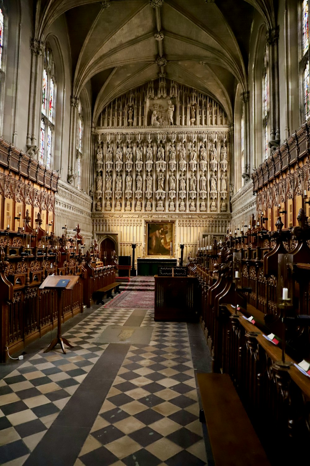 a church with a checkered floor and pews