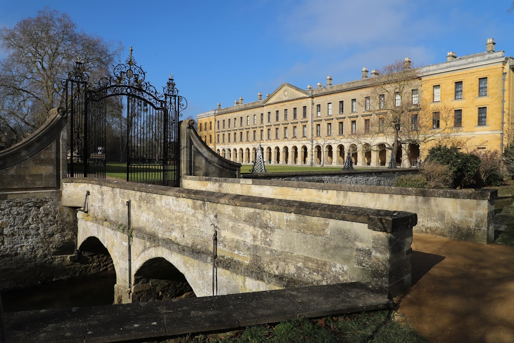 a stone bridge with a building in the background