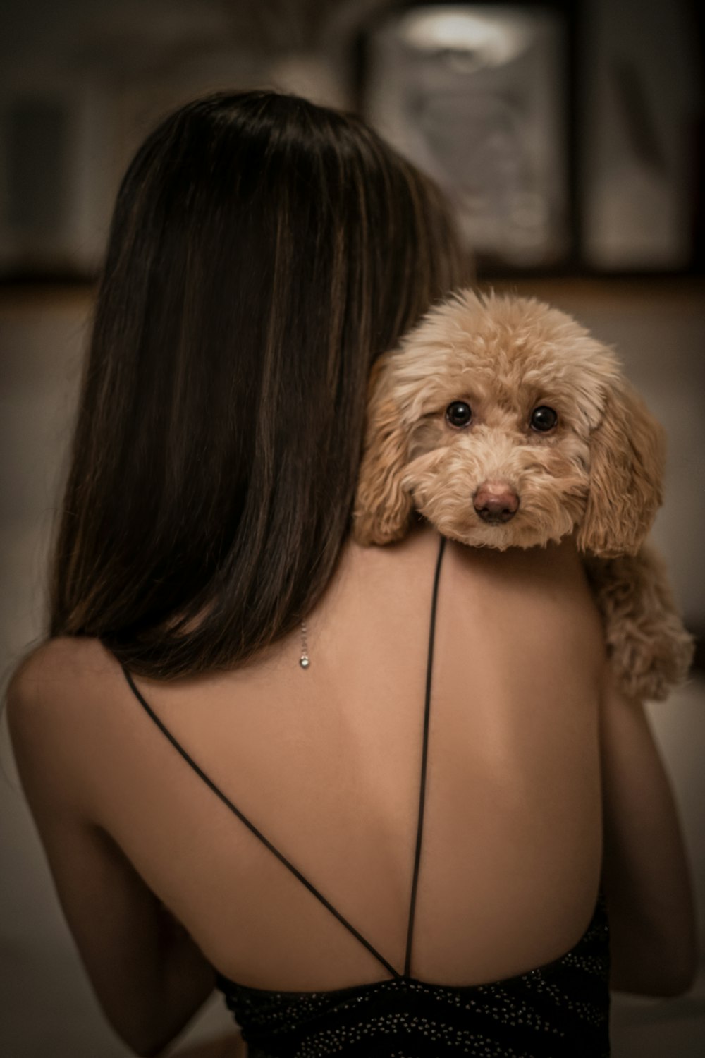 a woman holding a dog in her arms