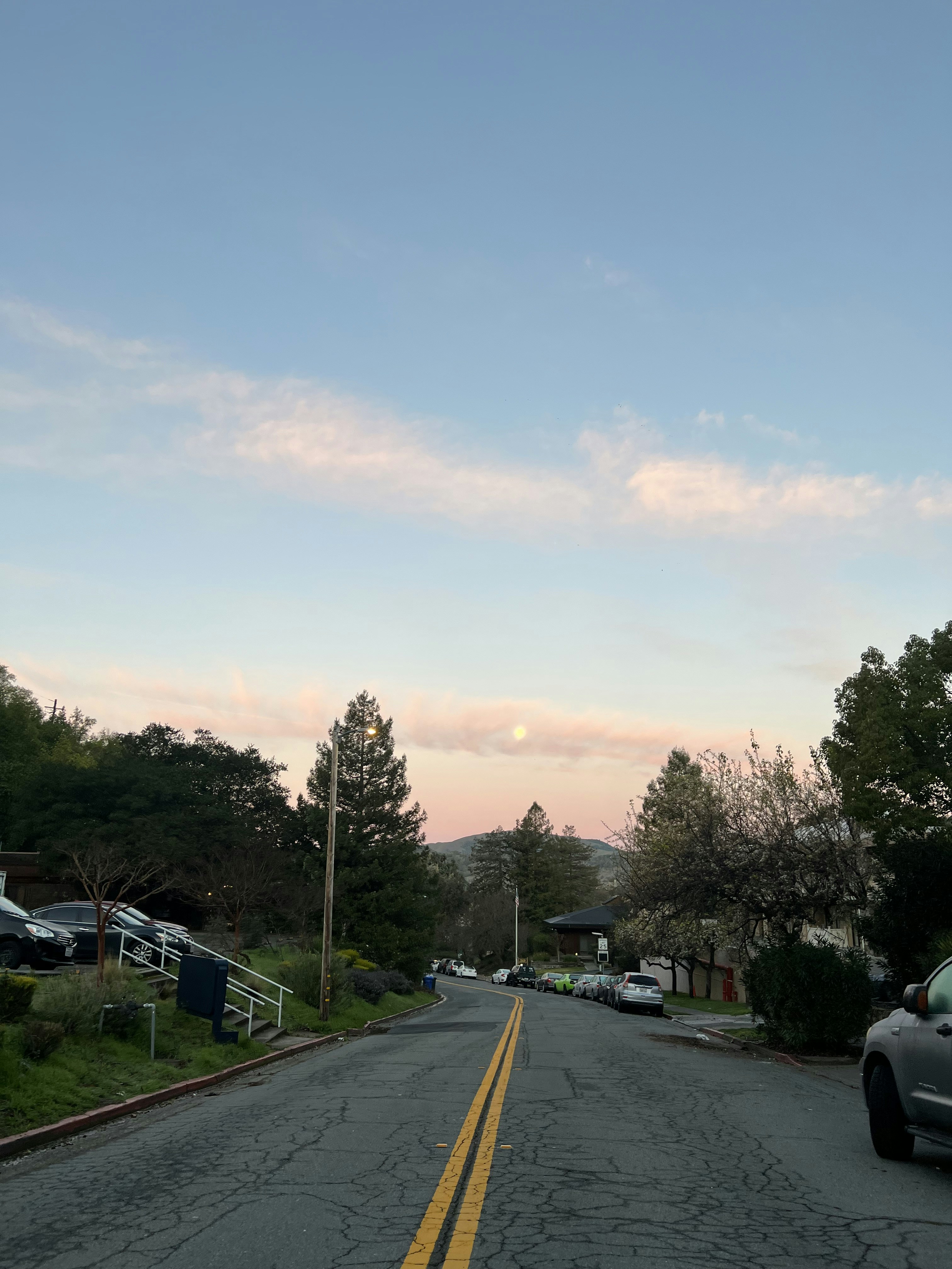 a street with cars parked on the side of it