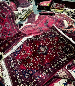 a pile of rugs and rugs on the floor