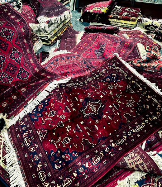 a pile of rugs and rugs on the floor