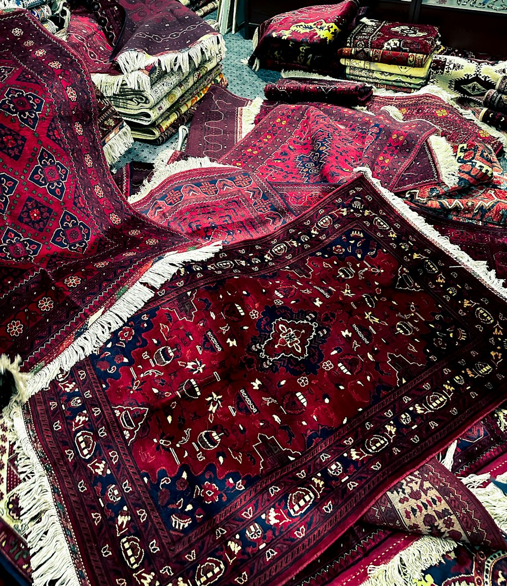 a pile of rugs and rugs on the floor