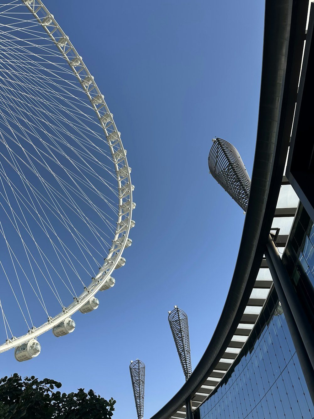 a large ferris wheel sitting next to a tall building