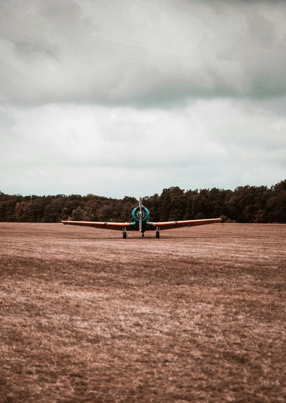 a person sitting on top of an airplane in a field