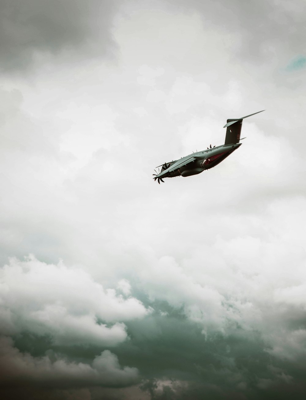 a small airplane flying through a cloudy sky