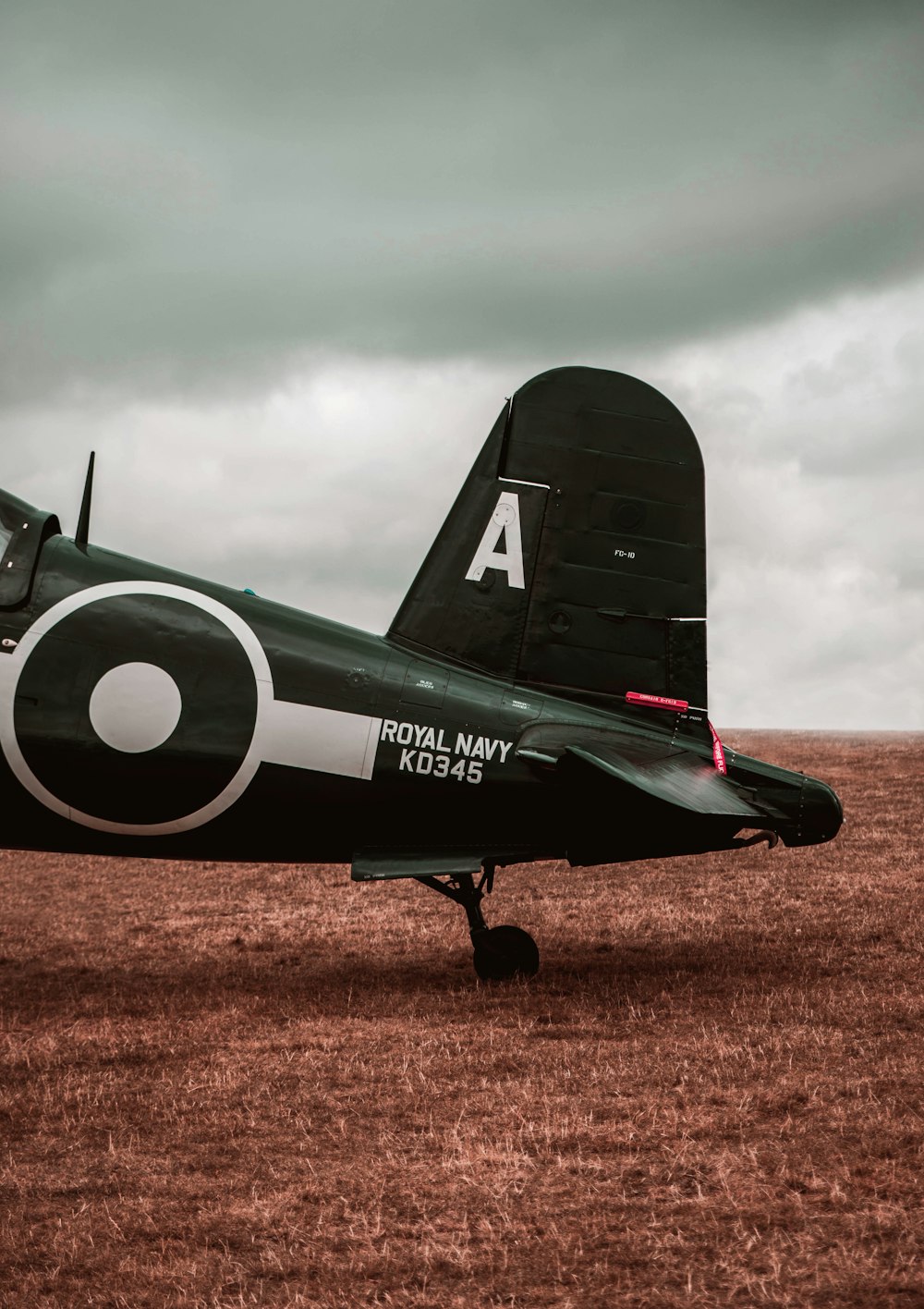 a small propeller plane sitting on top of a dry grass field