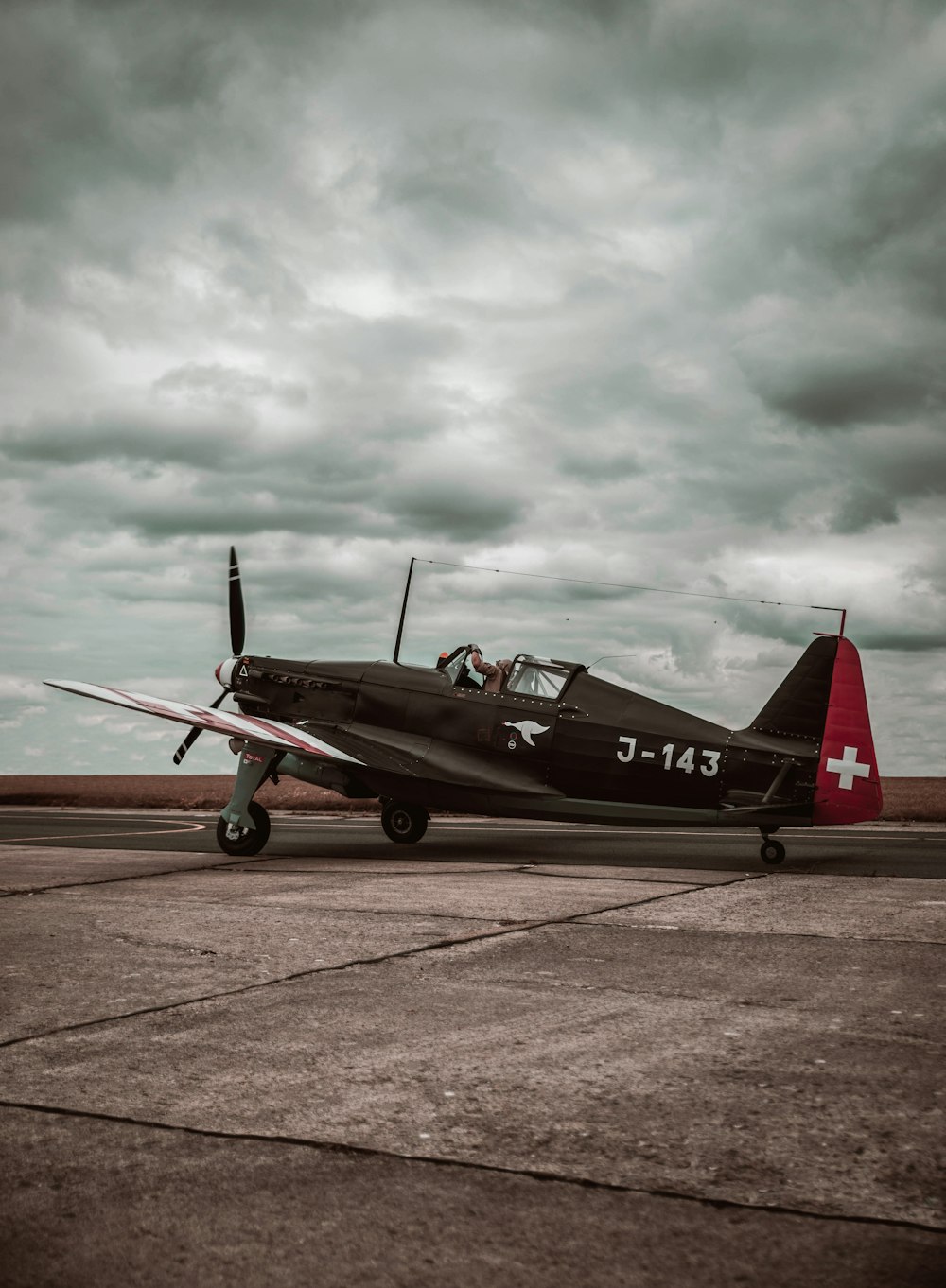 a small airplane sitting on top of an airport tarmac