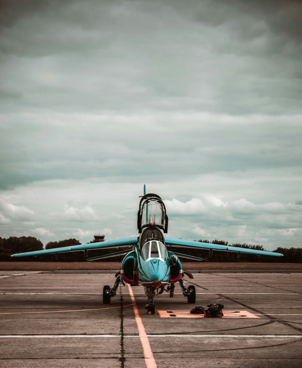 a small airplane sitting on top of an airport tarmac