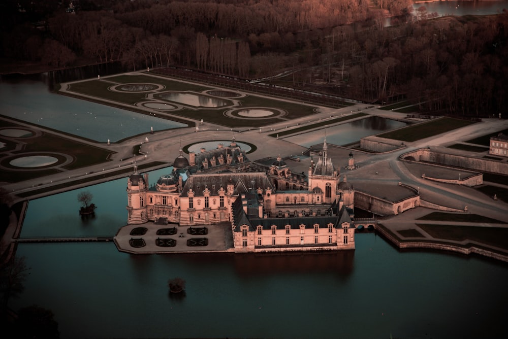 an aerial view of a castle in the middle of a lake