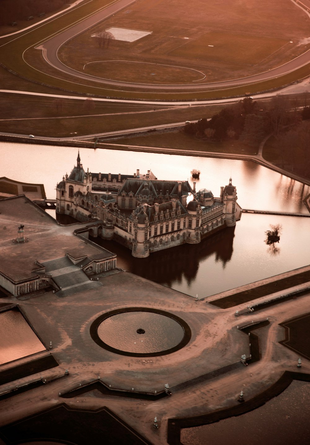 an aerial view of a castle in the middle of a lake