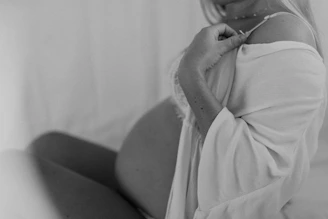 Close-up of a medical professional performing an obstetric ultrasound on a pregnant woman.