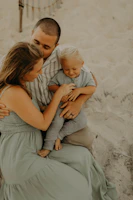 A cinematic capture of a family picnic with natural smiles and soft sand hues surrounding them.