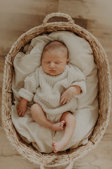 A happy baby peacefully sleeping in a merino wool sleep sack, wrapped in softness and warmth.