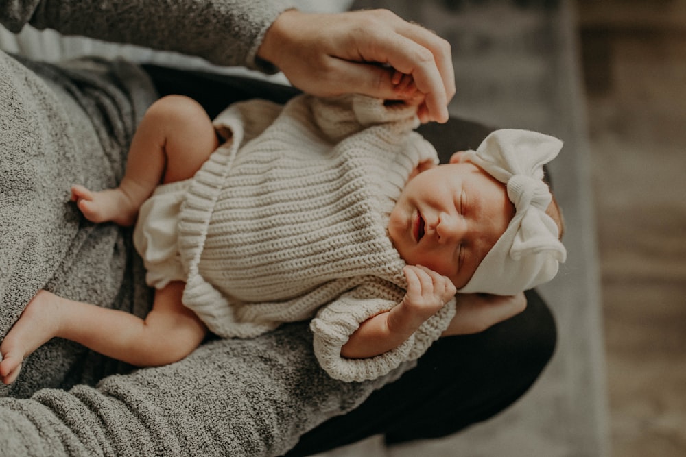 a woman holding a baby in her arms