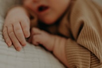 Close-up of a baby wearing a cozy, pastel blue outfit with gentle textures.