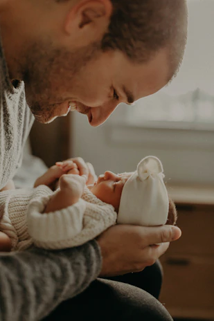 A tender moment capturing a newborn wrapped gently in soft blankets, held by loving parents.