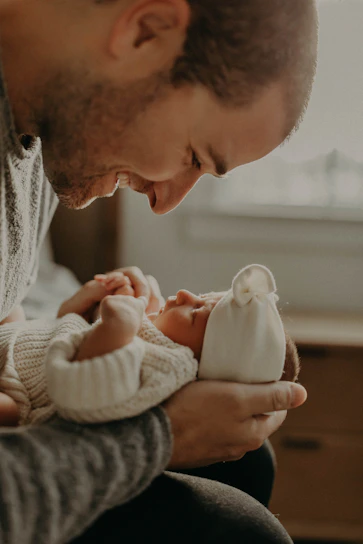 A tender moment capturing a newborn peacefully sleeping, wrapped in a soft blanket.