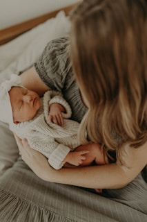 a woman holding a baby in her arms