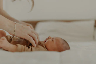 A parent gently measuring a toddler's chest with a soft measuring tape in a cozy room.