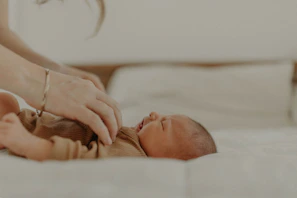 A pediatrician softly examining a tiny infant with attentive care.