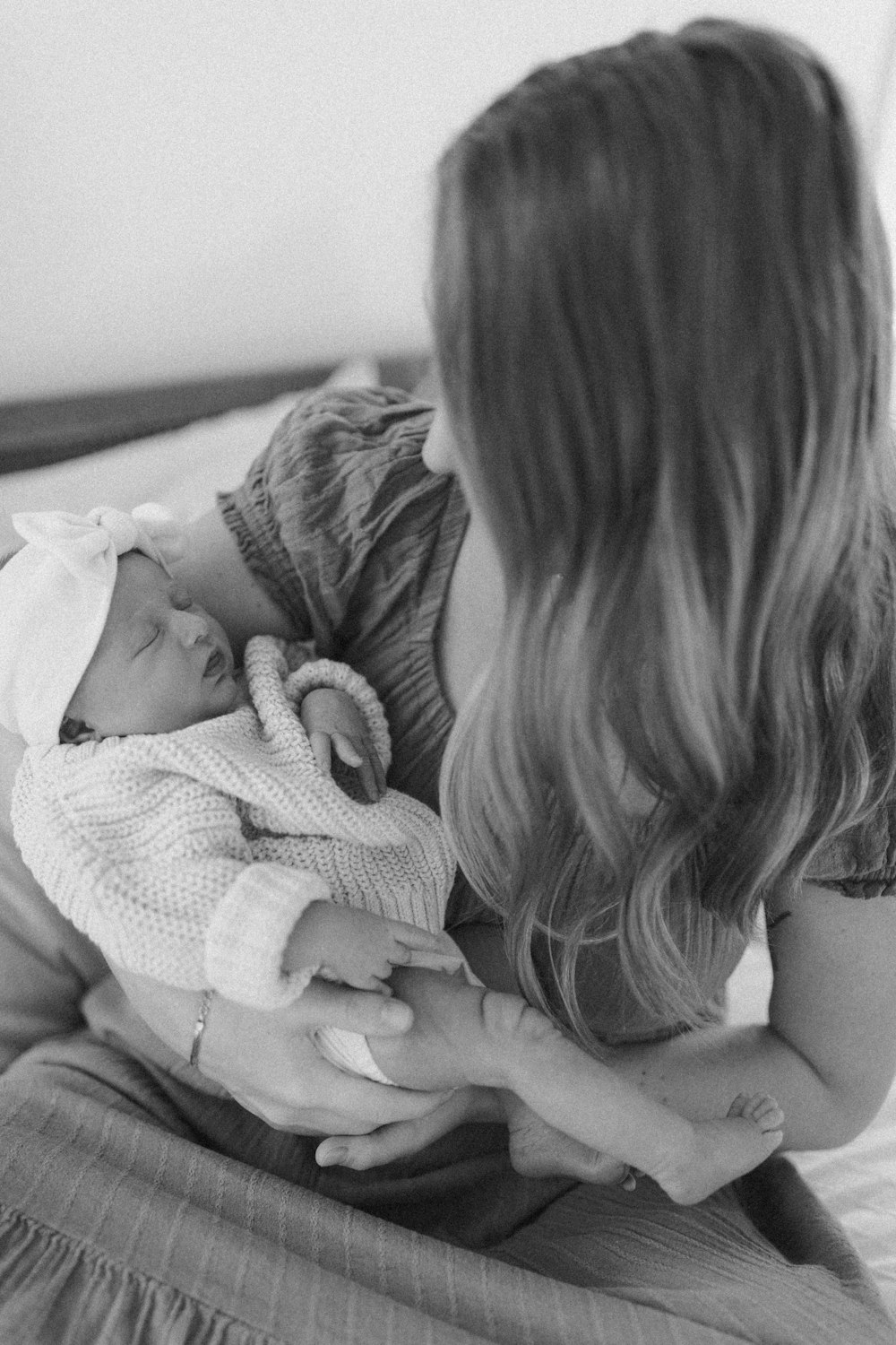 a woman holding a baby in her arms