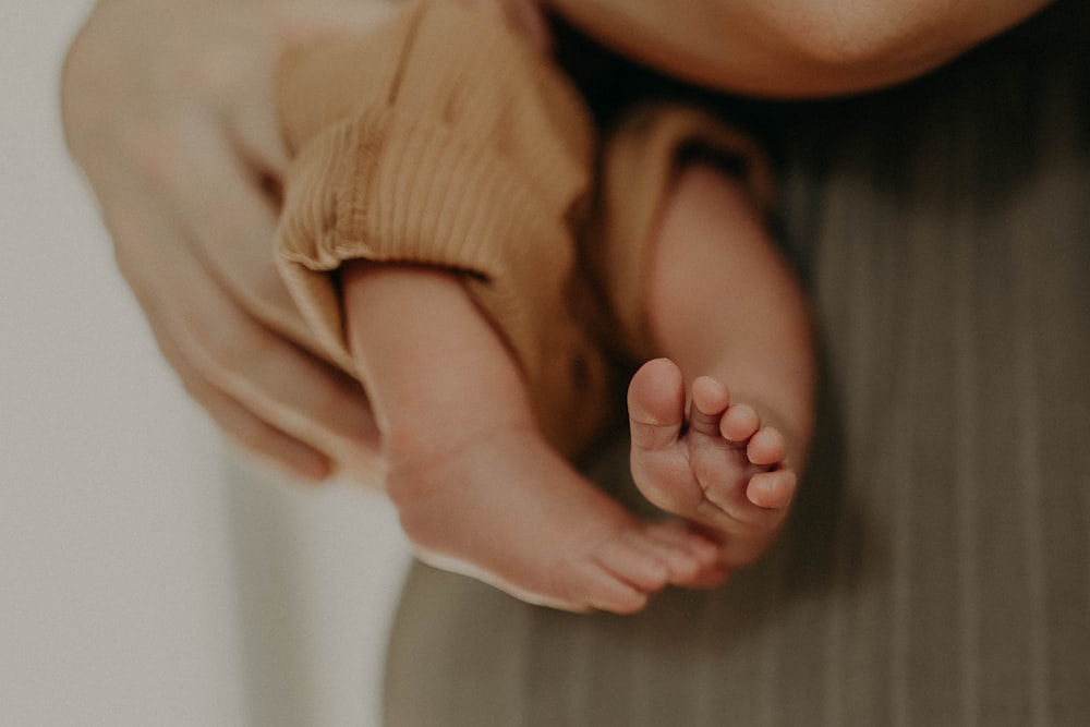 a person holding a baby in their arms