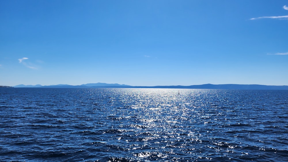 a body of water with a boat in the distance