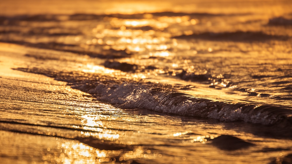 a close up of a wave on a beach