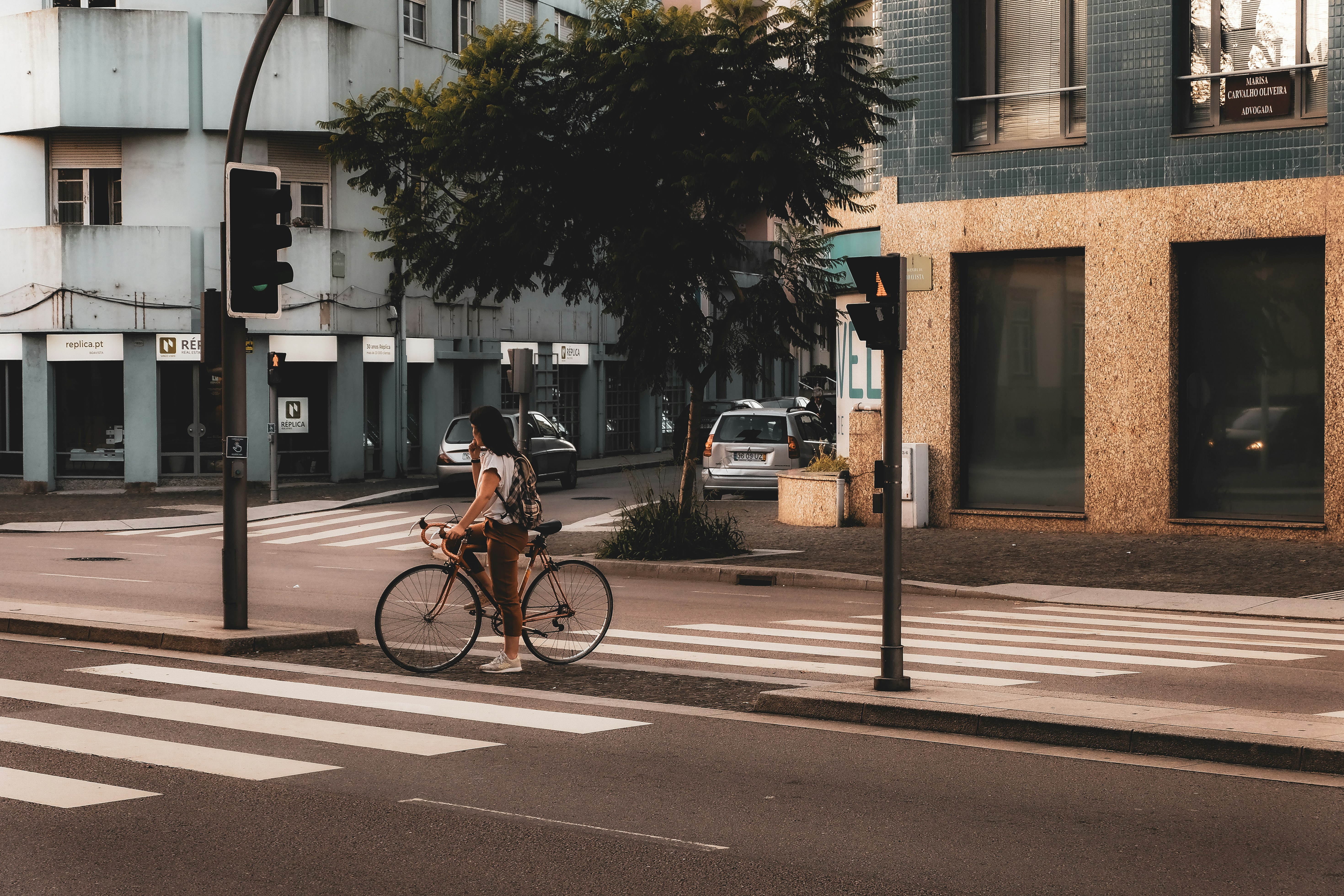 a person riding a bike on a city street