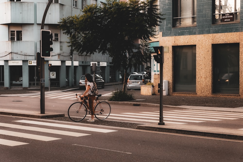 a person riding a bike on a city street