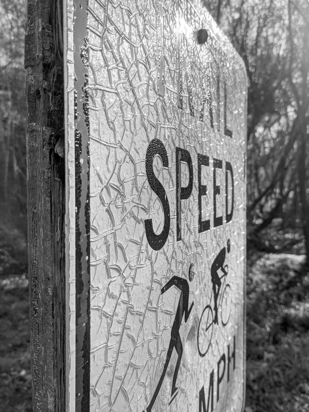 a black and white photo of a speed limit sign